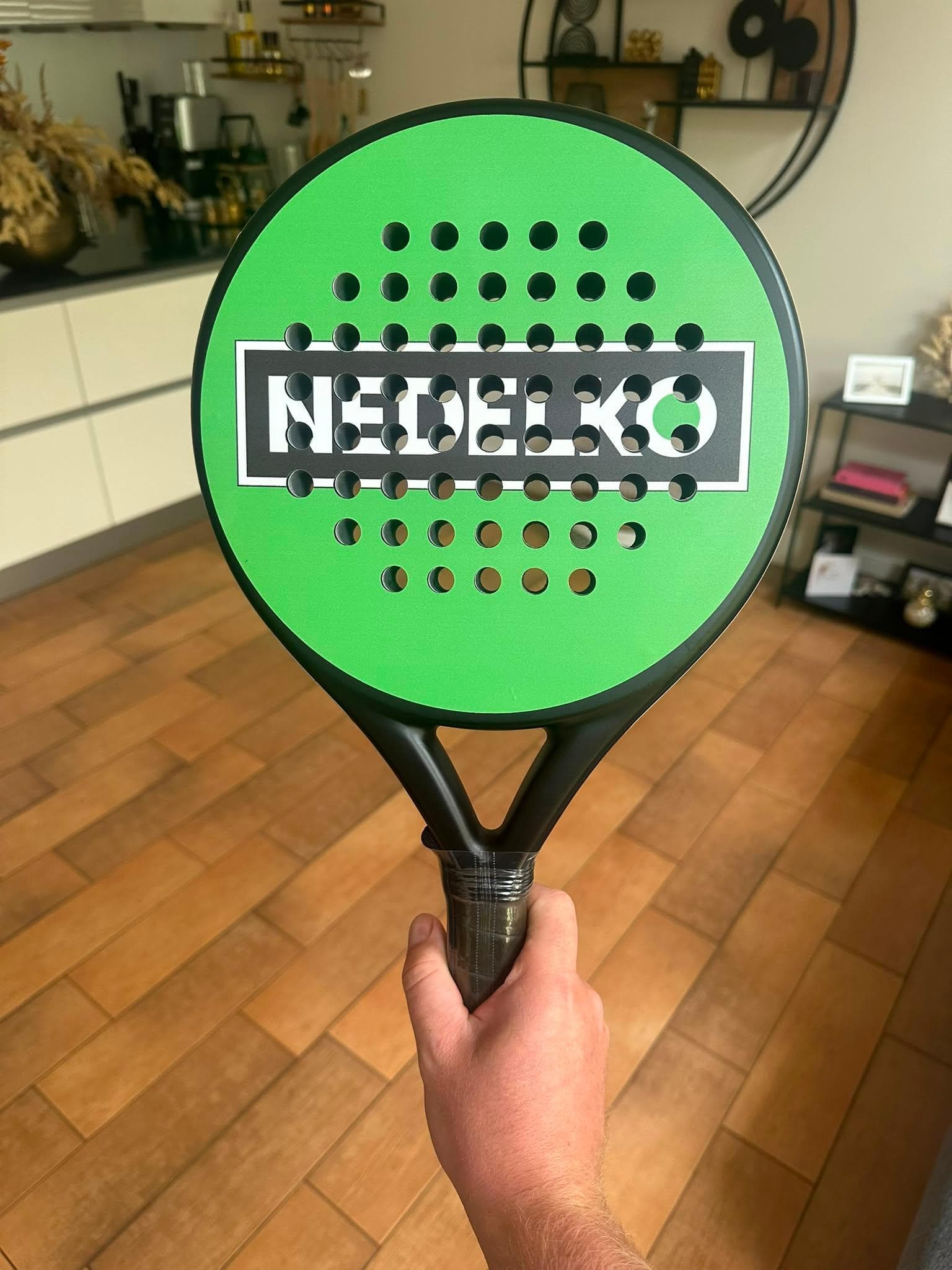 Custom padel racket in bright green with the name NEDELKO on the face